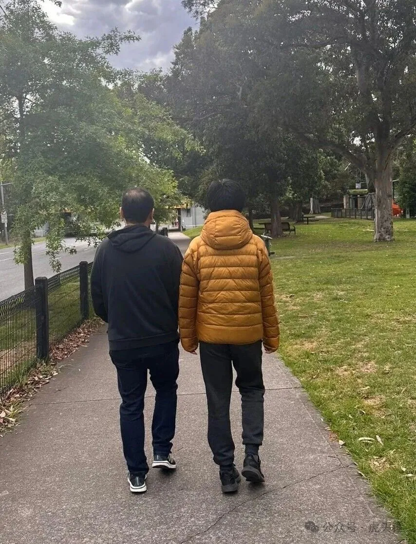 Ming walking beside his son